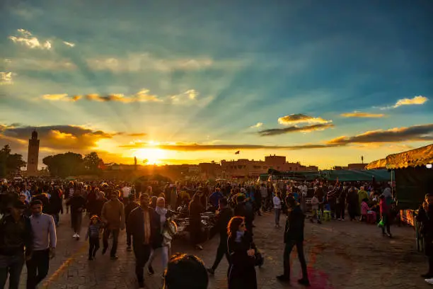 Djemaa el-Fna square with street performers and market stalls at sunset, Marrakech